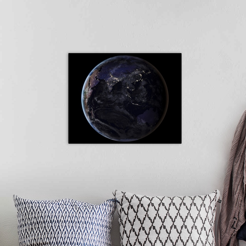 A bohemian room featuring Full Earth showing city lights of Asia at night.
