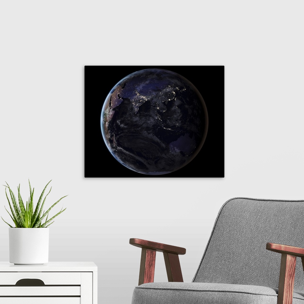A modern room featuring Full Earth showing city lights of Asia at night.