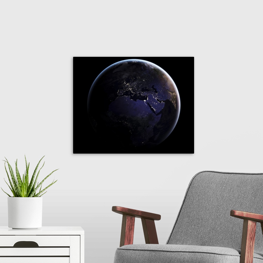 A modern room featuring Full Earth showing city lights of Europe at night.