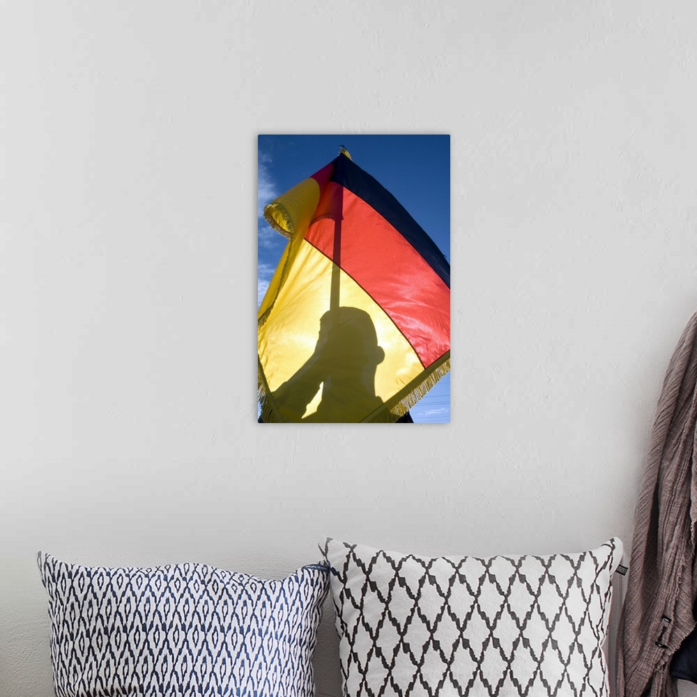 A bohemian room featuring German Air Force Airman holds the German flag.