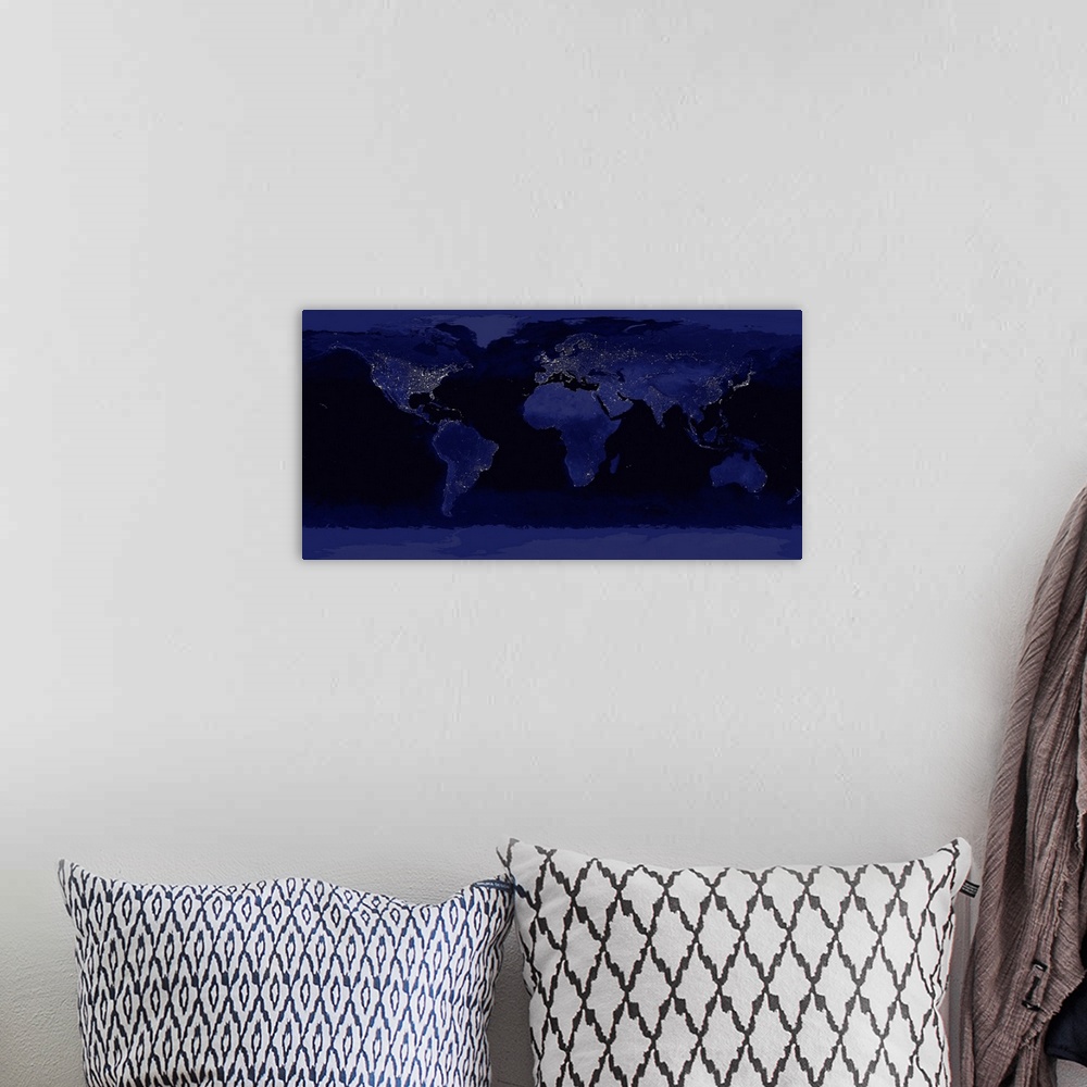 A bohemian room featuring A large photograph of the world taken at night showcasing city lights.