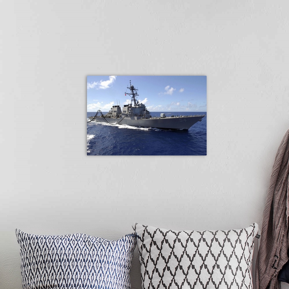 A bohemian room featuring Big canvas photo art of a navy ship in the ocean.