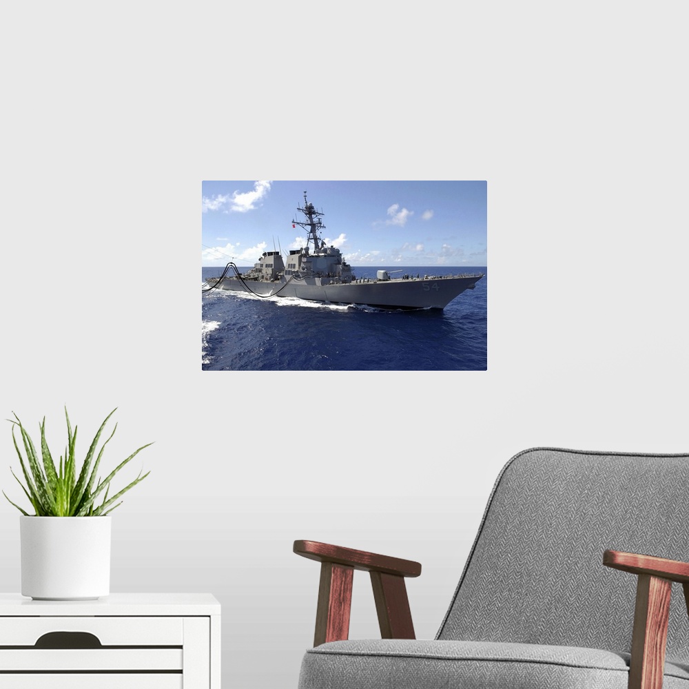 A modern room featuring Big canvas photo art of a navy ship in the ocean.