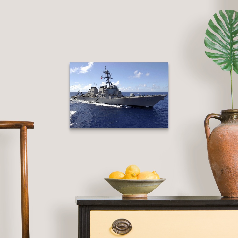 A traditional room featuring Big canvas photo art of a navy ship in the ocean.