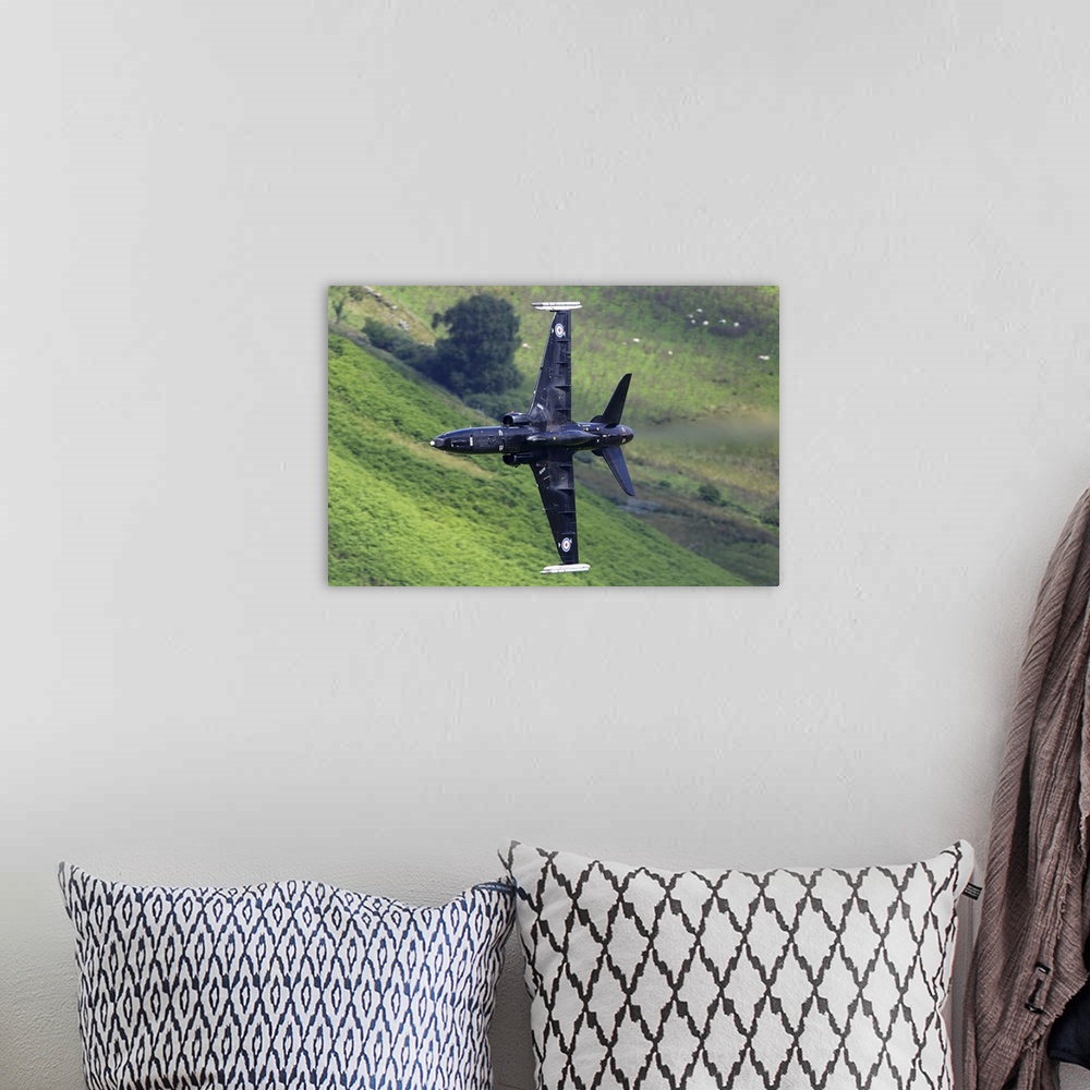 A bohemian room featuring Hawk T2 training aircraft of Royal Air Force during training flight in the Machynlleth loop area,...