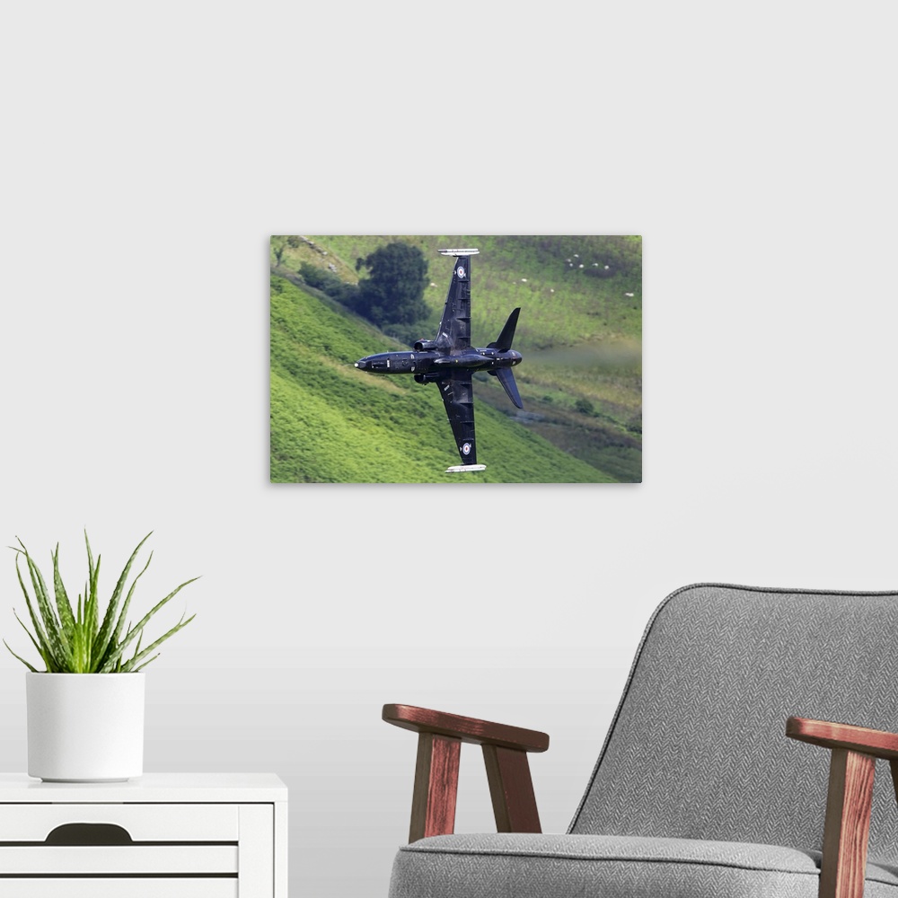 A modern room featuring Hawk T2 training aircraft of Royal Air Force during training flight in the Machynlleth loop area,...