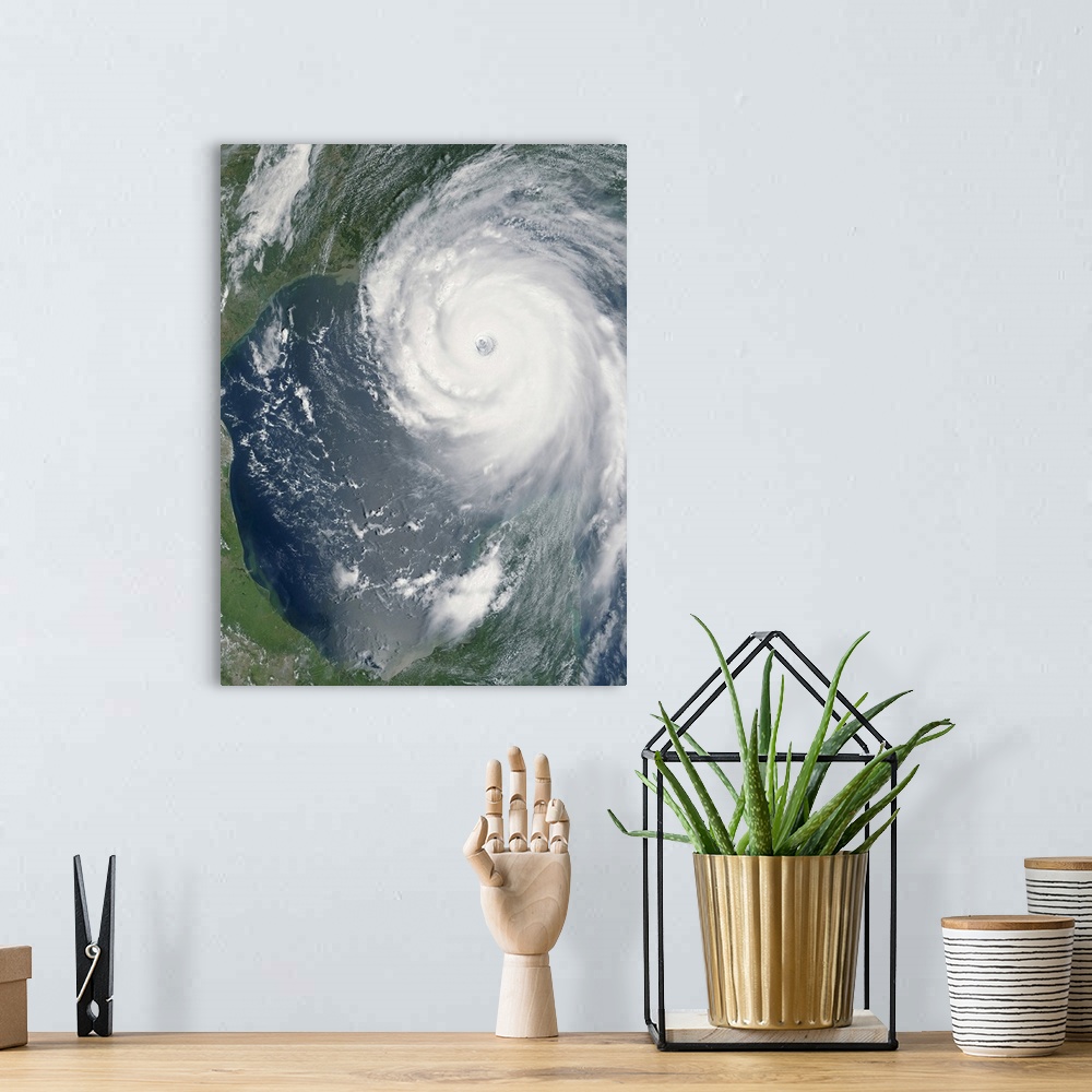 A bohemian room featuring Big, vertical, aerial photograph of Hurricane Katrina swirling as she approaches land.