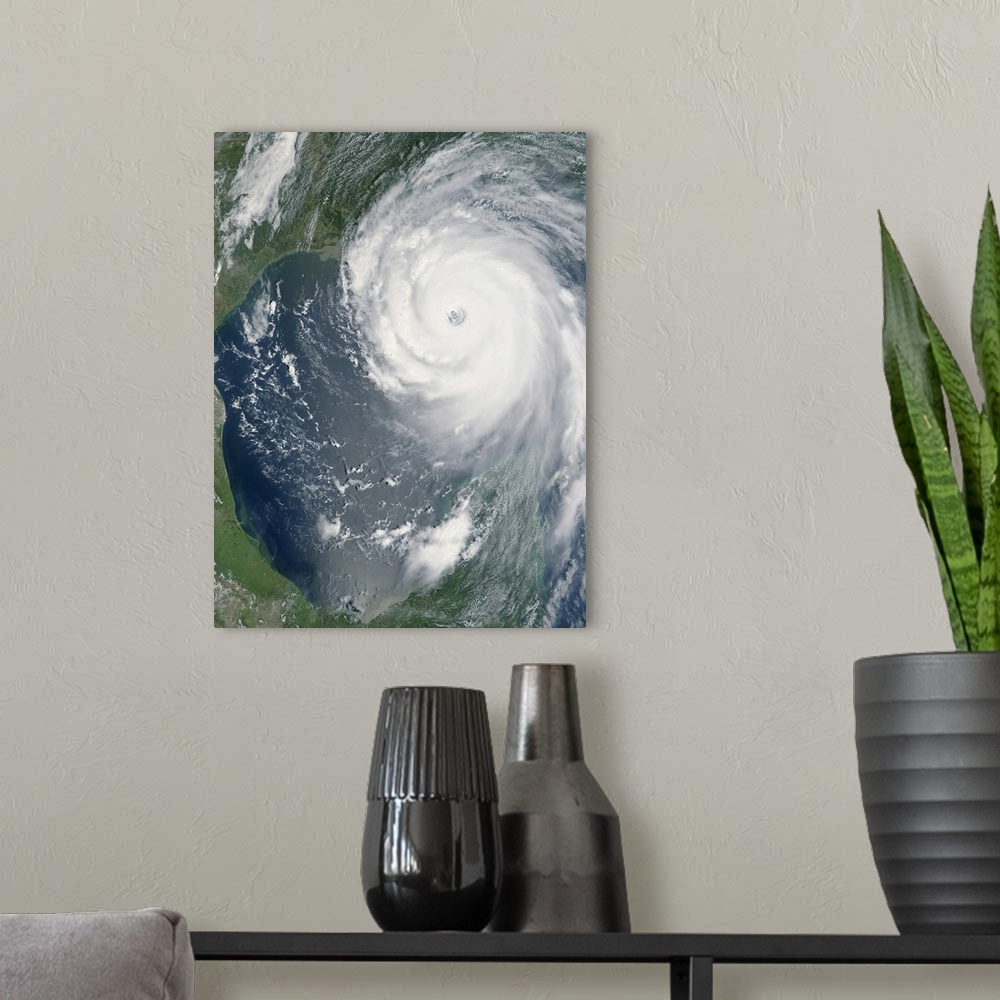 A modern room featuring Big, vertical, aerial photograph of Hurricane Katrina swirling as she approaches land.