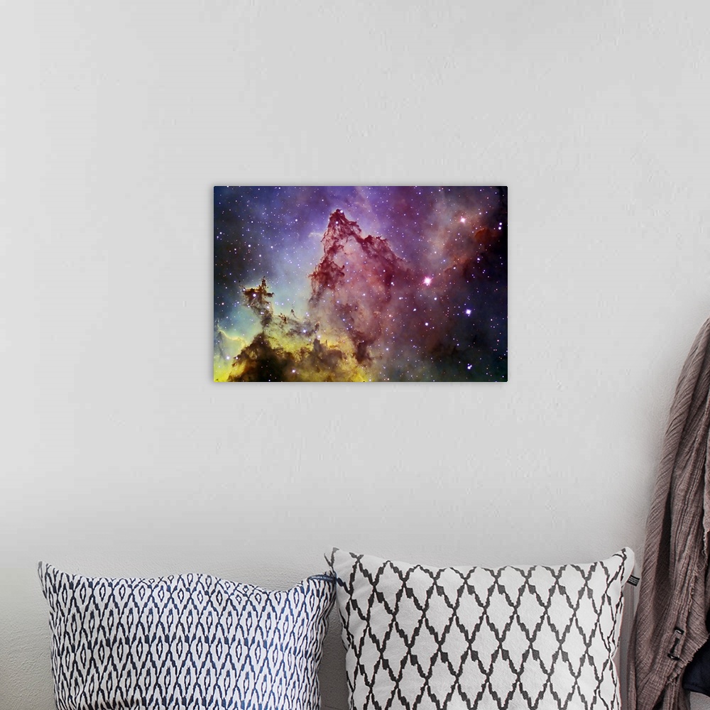 A bohemian room featuring Space photography of a colorful nebula with stars in the background.