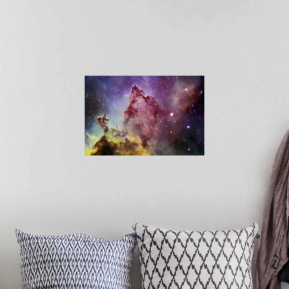 A bohemian room featuring Space photography of a colorful nebula with stars in the background.