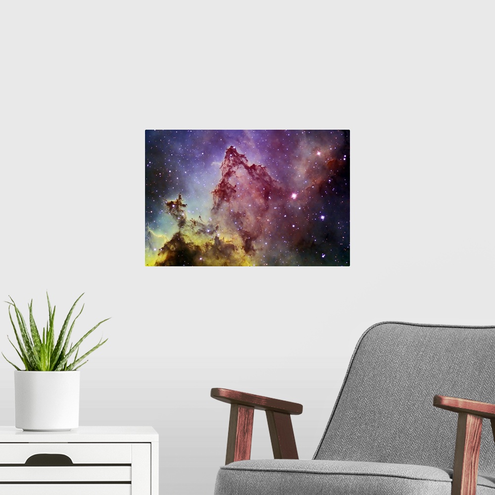 A modern room featuring Space photography of a colorful nebula with stars in the background.