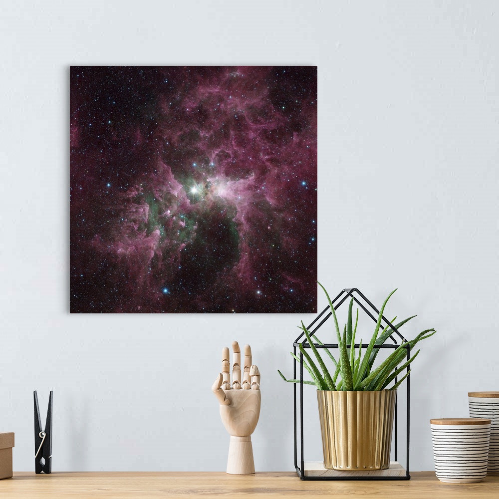 A bohemian room featuring Infrared view of the Carina Nebula. The bright star at the center of the nebula is Eta Carinae, o...