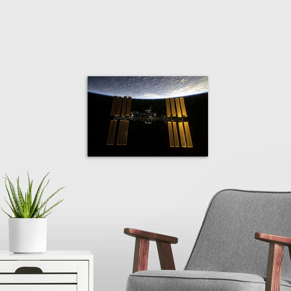 A modern room featuring International Space Station backdropped against Earths horizon