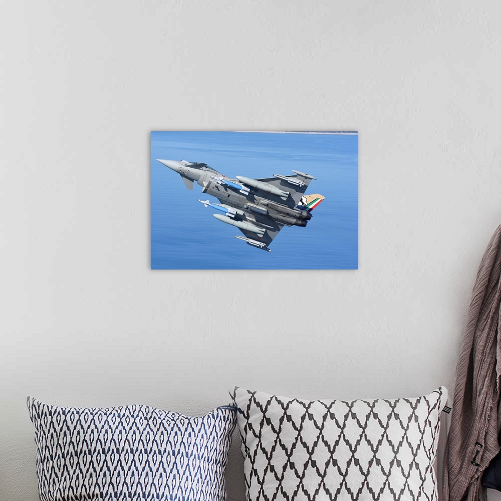 A bohemian room featuring Italian Air Force Eurofighter F-2000 armed with bombs and targeting pod.
