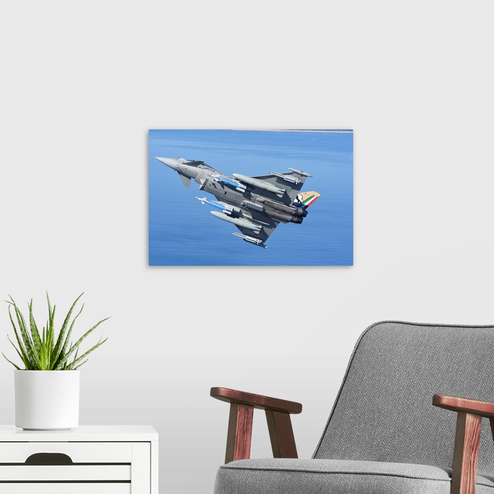 A modern room featuring Italian Air Force Eurofighter F-2000 armed with bombs and targeting pod.