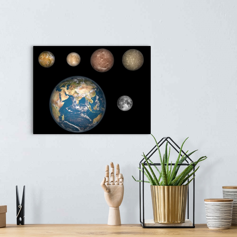A bohemian room featuring Artist's concept of Jupiter's four largest satellites laid out above the Earth and it's moon.