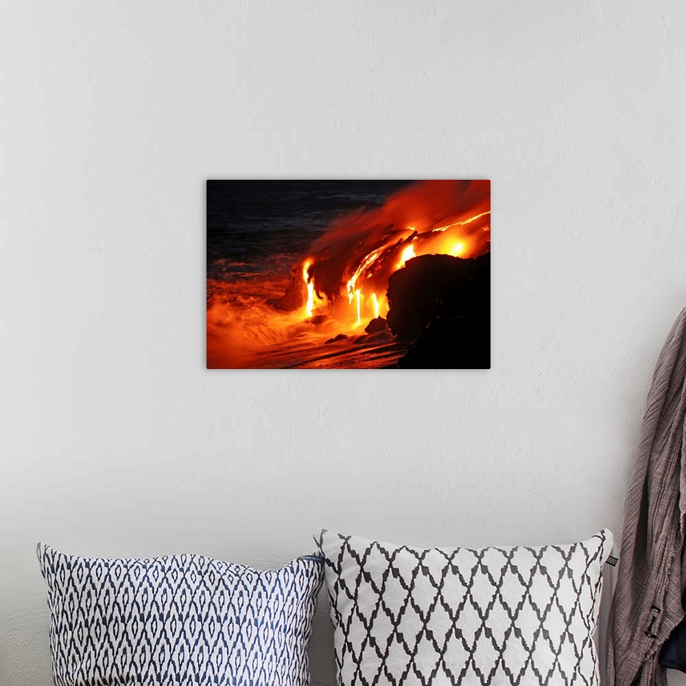 A bohemian room featuring Photograph of magma running off a rock into the ocean at night.