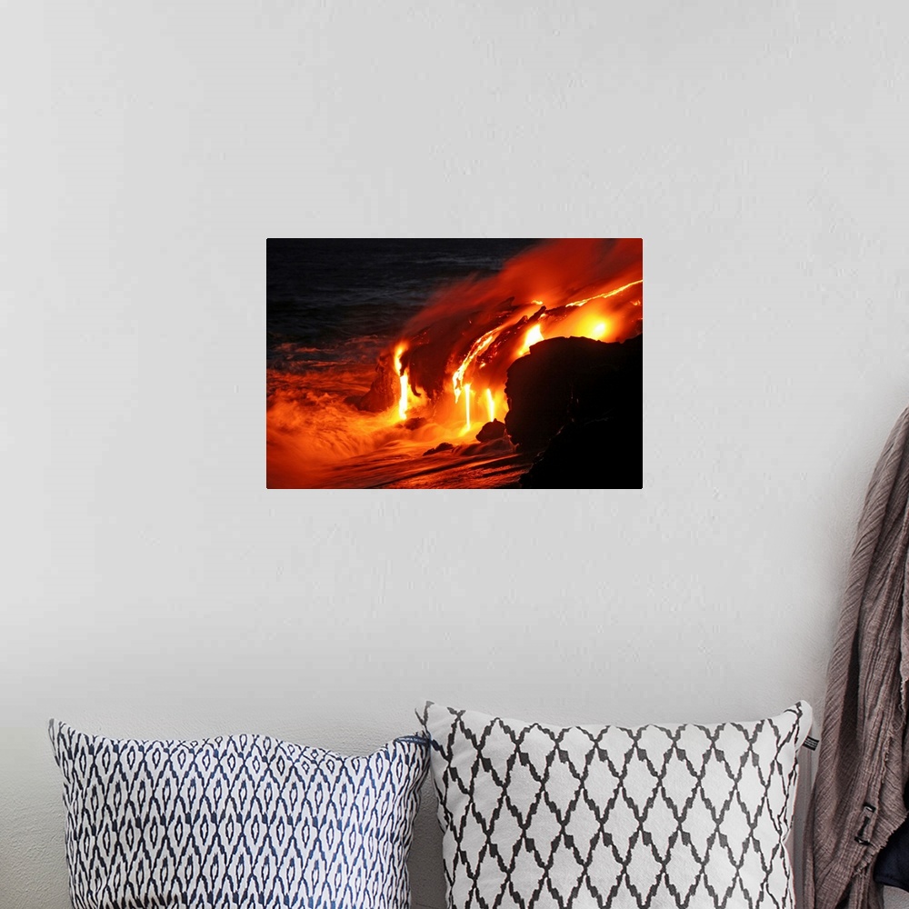 A bohemian room featuring Photograph of magma running off a rock into the ocean at night.