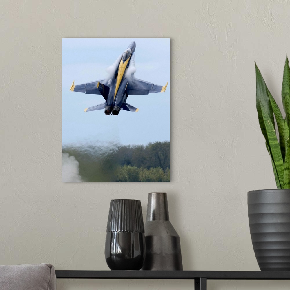 A modern room featuring Lead solo pilot of the Blue Angels performs a high performance climb