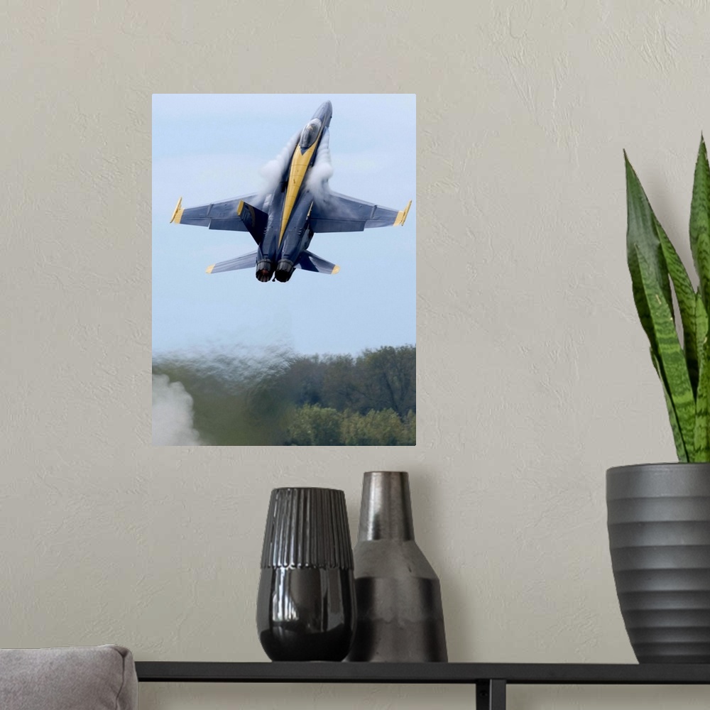 A modern room featuring Lead solo pilot of the Blue Angels performs a high performance climb