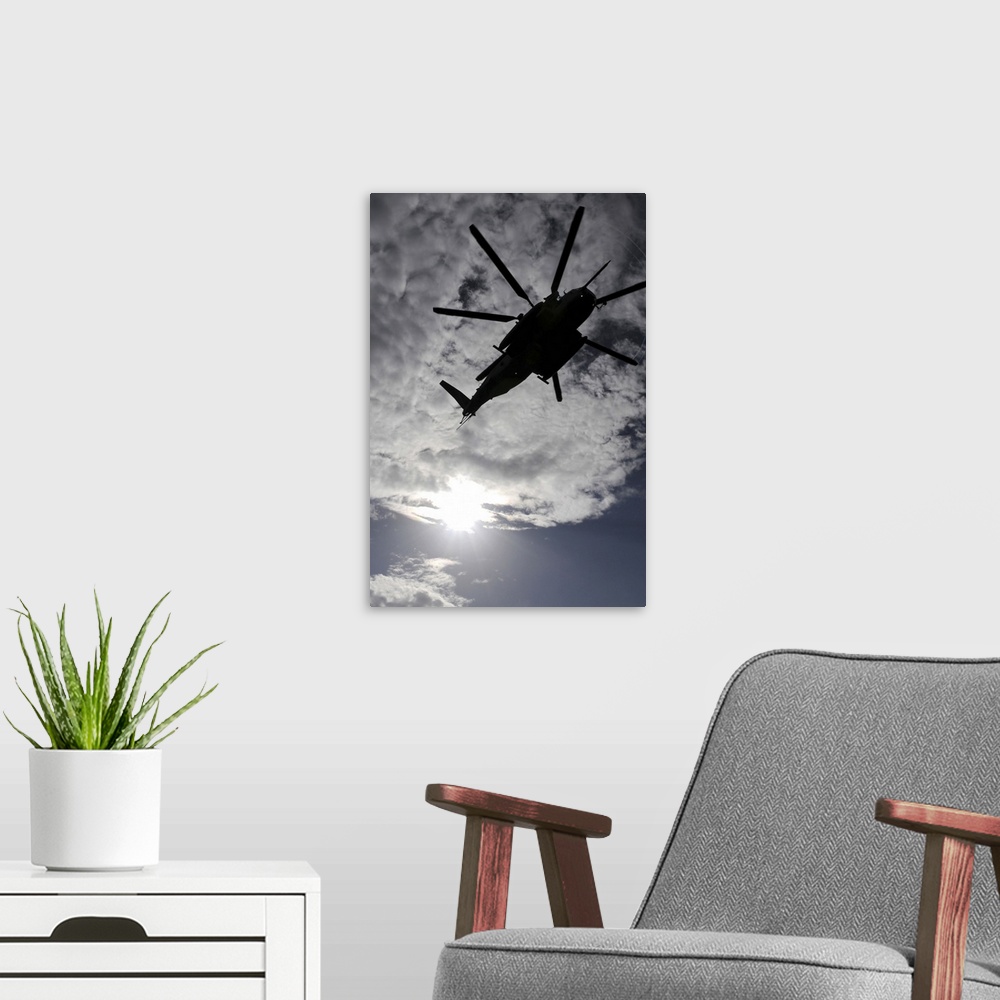A modern room featuring Low angle view of a CH53E Super Stallion helicopter in flight