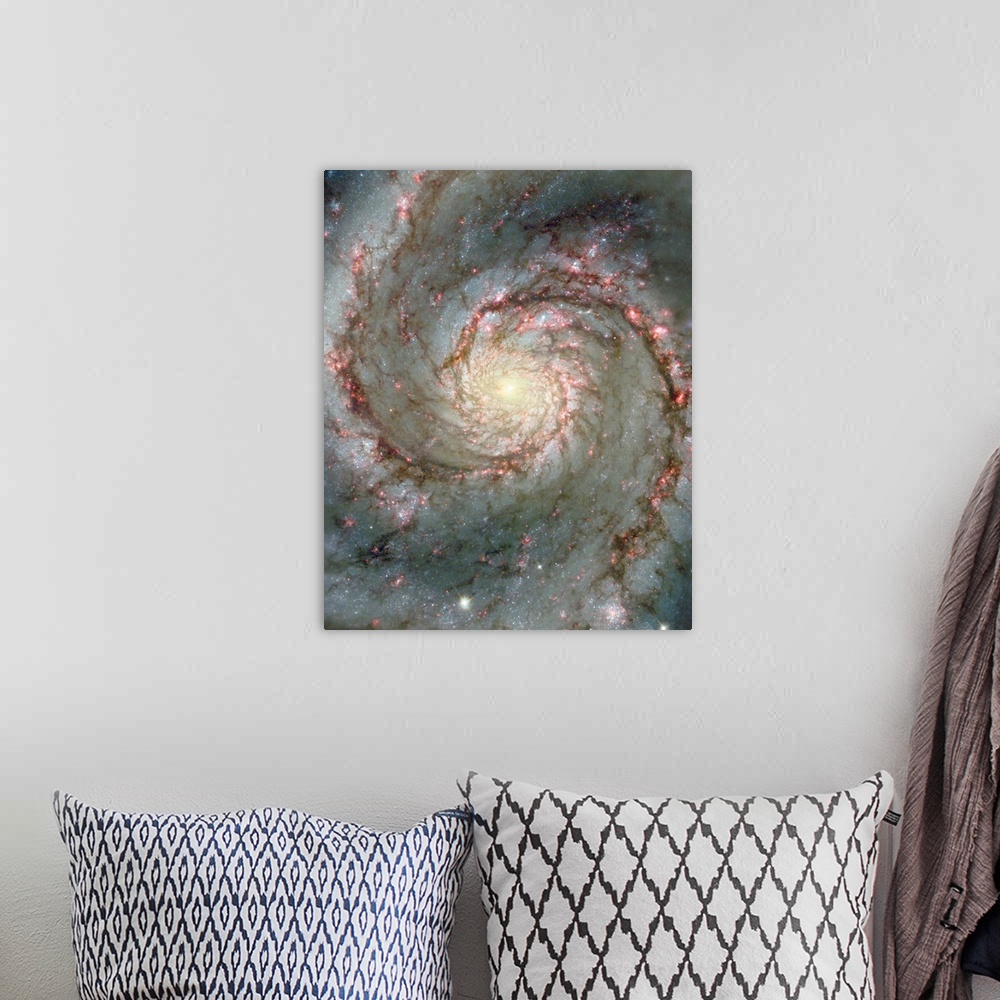 A bohemian room featuring Space photograph of a spiral galaxy, circling counter-clockwise and trailing its arms full of stars.