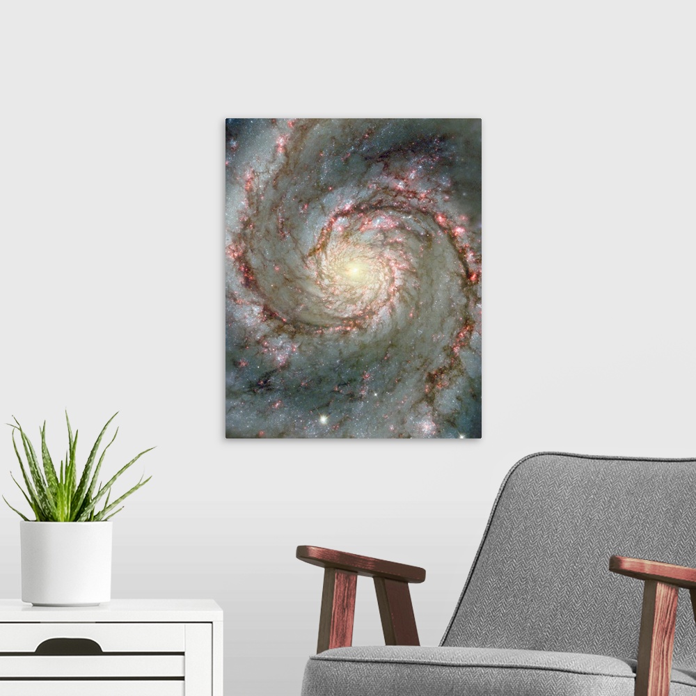 A modern room featuring Space photograph of a spiral galaxy, circling counter-clockwise and trailing its arms full of stars.