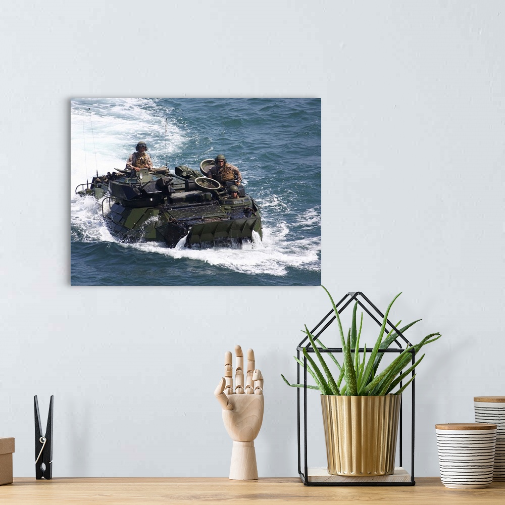A bohemian room featuring Marines operate an amphibious assault vehicle.