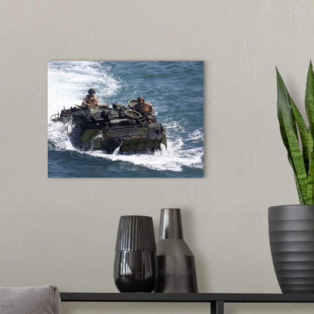 A modern room featuring Marines operate an amphibious assault vehicle.