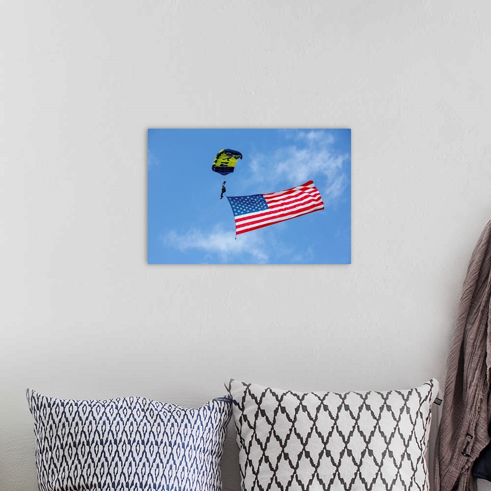 A bohemian room featuring Member of the U.S. Navy Parachute Team flies the American Flag.