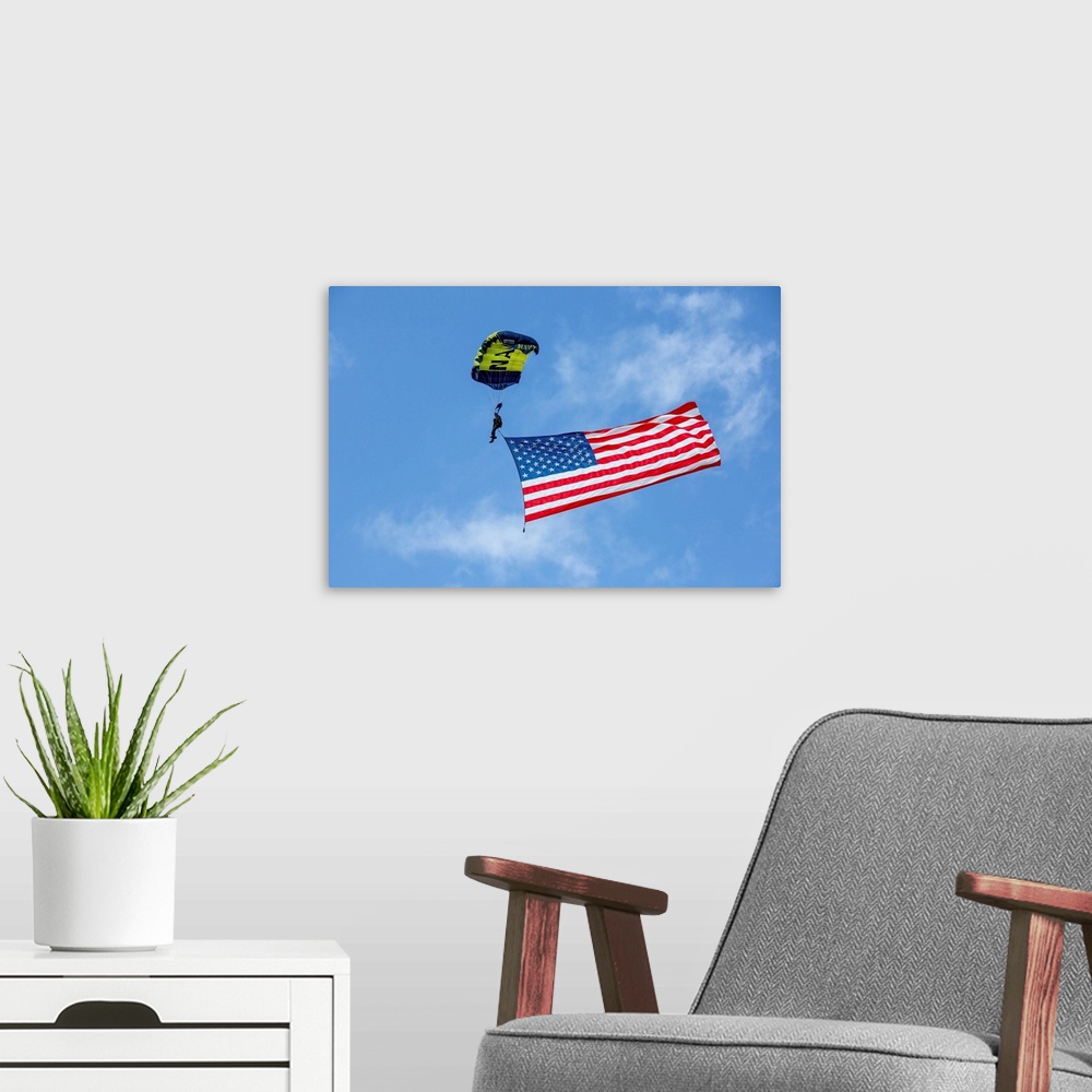 A modern room featuring Member of the U.S. Navy Parachute Team flies the American Flag.