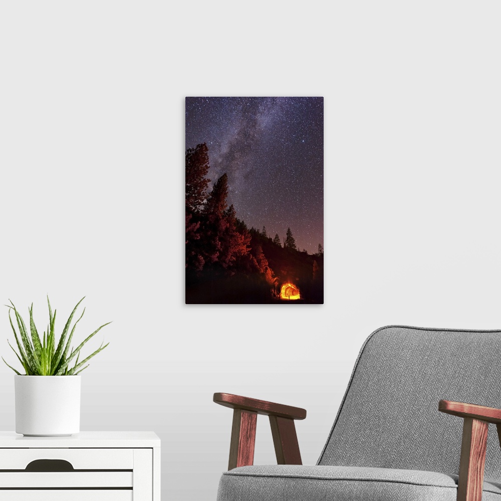 A modern room featuring The summer Milky Way rises over the mountain while the tunnel blazes with light in this long expo...