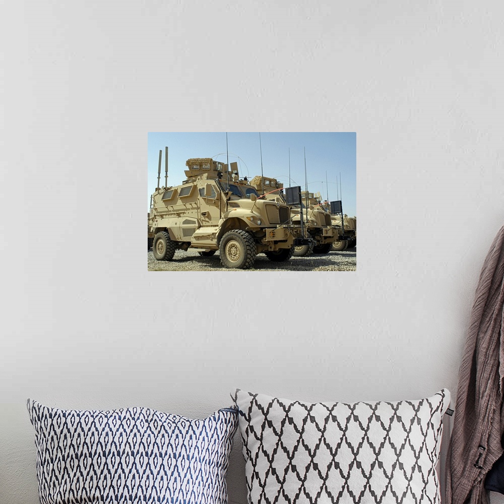 A bohemian room featuring Mine Resistant Ambush Protected vehicles sit in parking area at Joint Base Balad Iraq