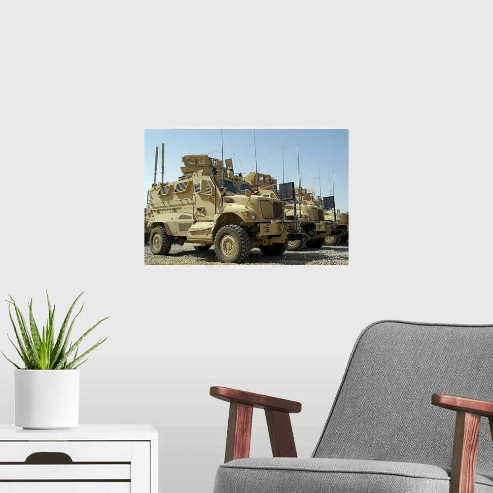 A modern room featuring Mine Resistant Ambush Protected vehicles sit in parking area at Joint Base Balad Iraq
