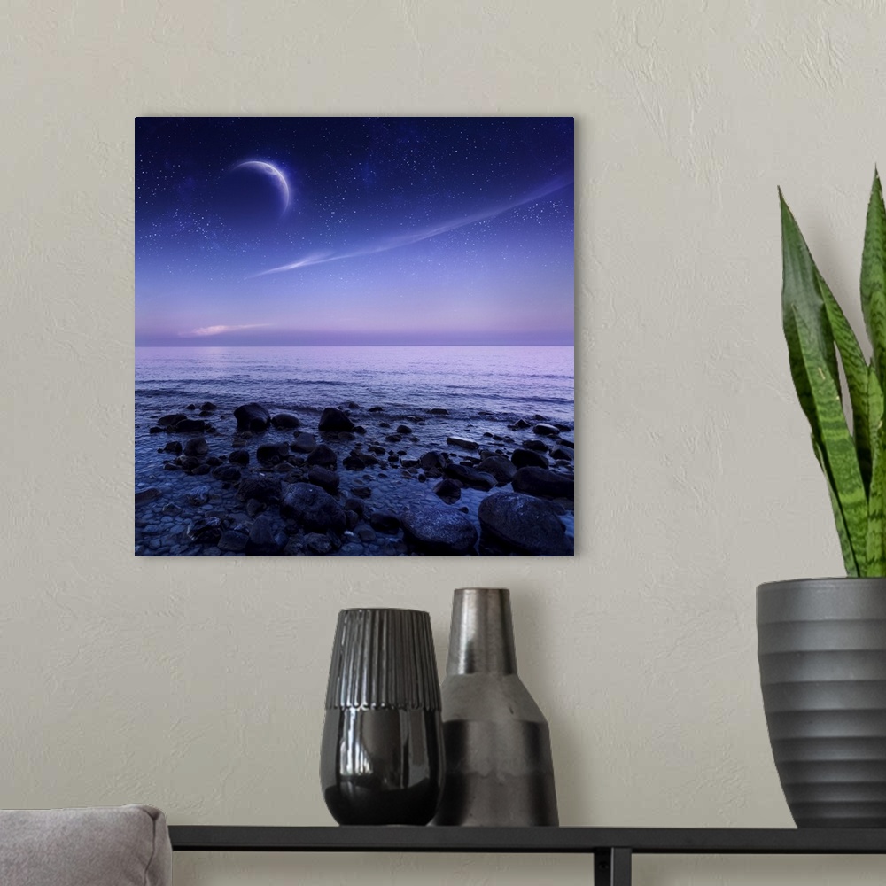 A modern room featuring Moon rising over rocky seaside against starry sky.