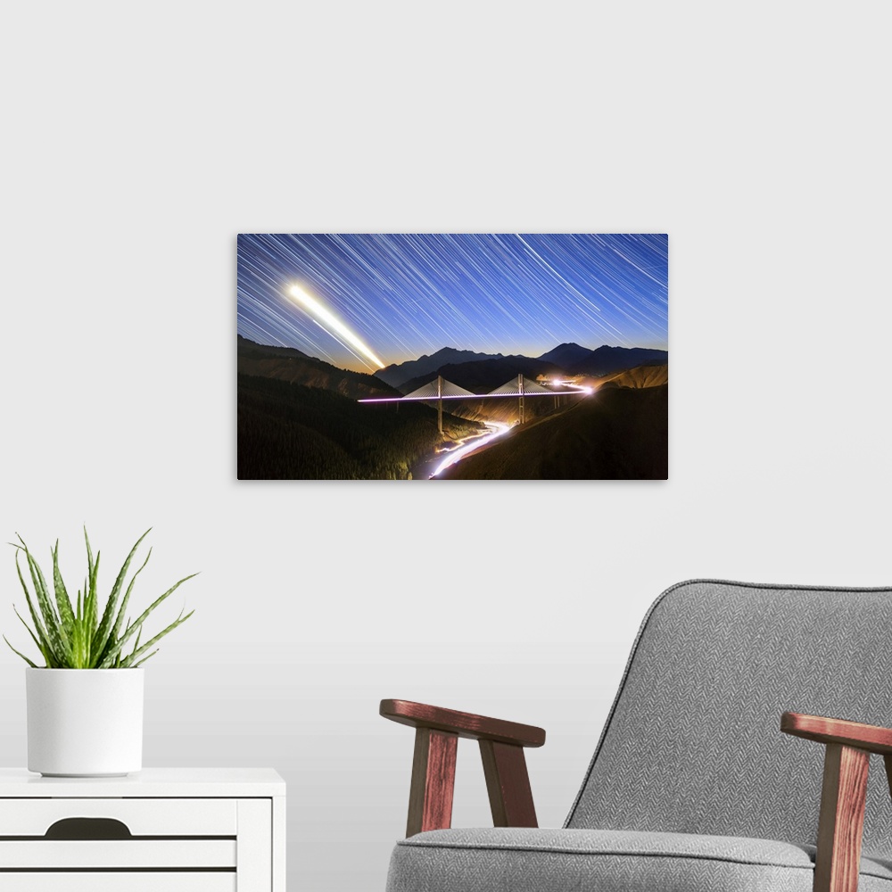 A modern room featuring Moon, star and car light trails as they set above the Guozigou Bridge in Xinjiang, Northwest China.