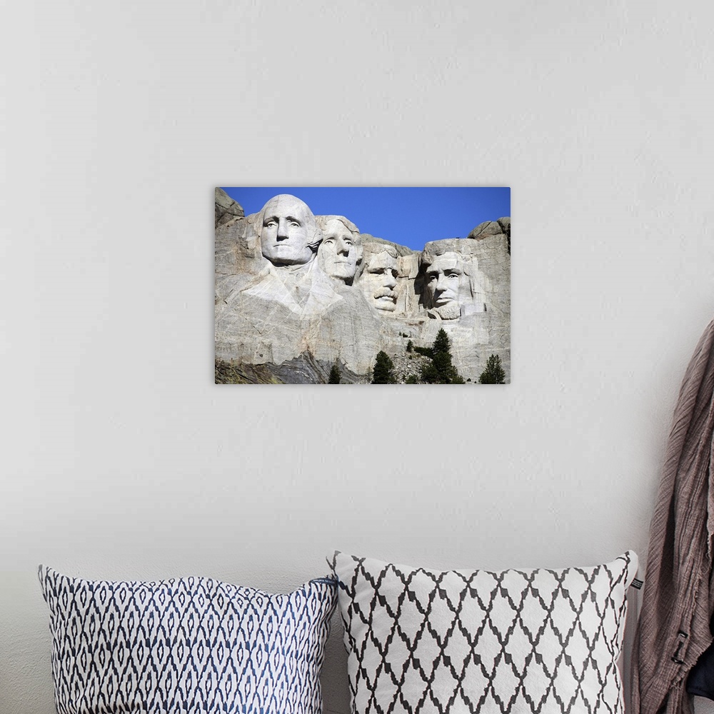 A bohemian room featuring Picture of the four stone heads of past United States Presidents that make up the National Park o...