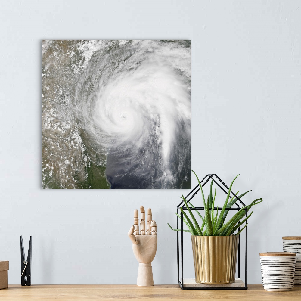 A bohemian room featuring Natural color satellite image of Hurrican Harvey making landfall on Texas.
