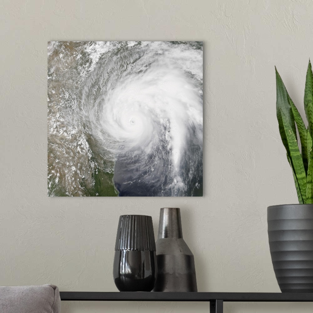 A modern room featuring Natural color satellite image of Hurrican Harvey making landfall on Texas.