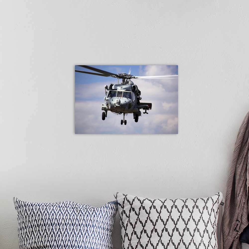 A bohemian room featuring Navy pilots in a SH60F Seahawk conduct final approach for landing