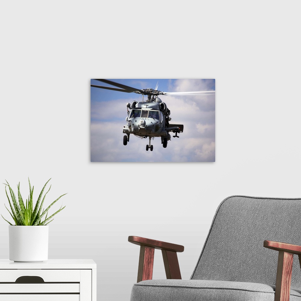 A modern room featuring Navy pilots in a SH60F Seahawk conduct final approach for landing