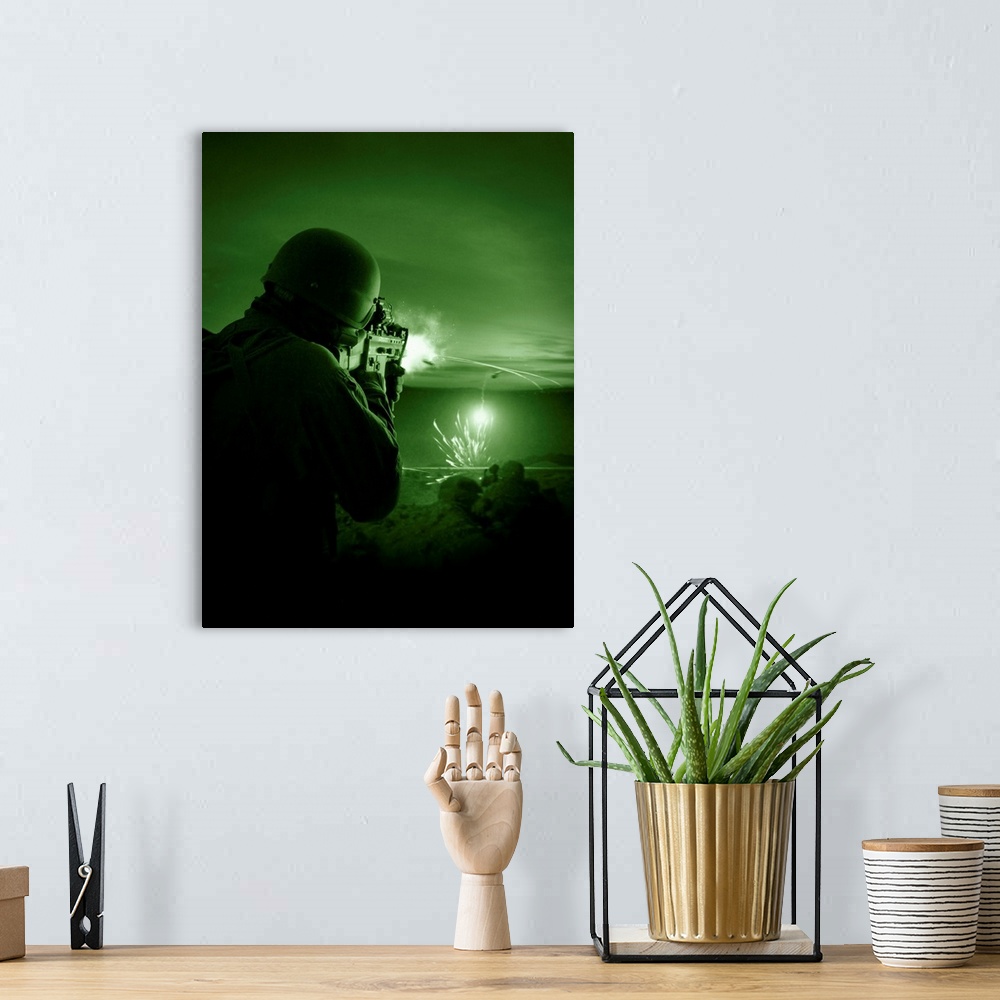 A bohemian room featuring Night vision view of a special operations forces soldier firing his weapon during combat.
