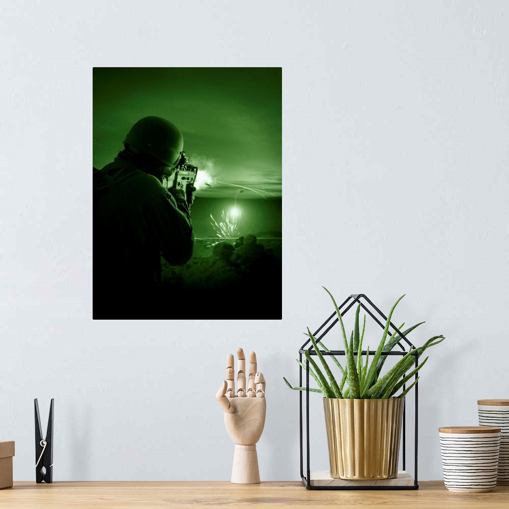 A bohemian room featuring Night vision view of a special operations forces soldier firing his weapon during combat.