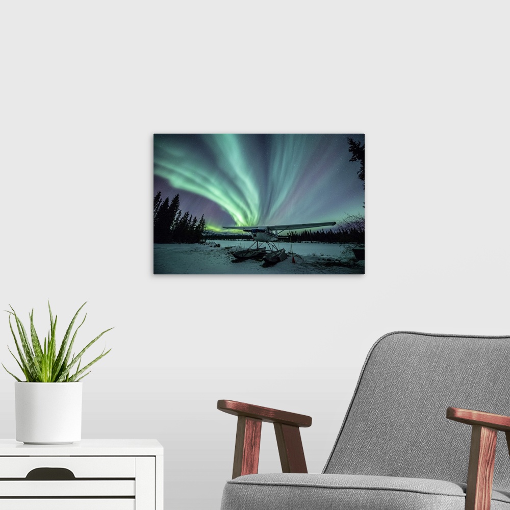 A modern room featuring Northern lights above a plane at night, Whitehorse, Yukon, Canada.
