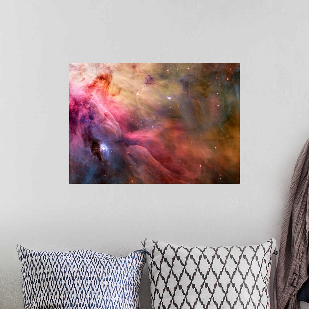 A bohemian room featuring Big canvas decor of a multicolored nebula with stars sprinkled around.