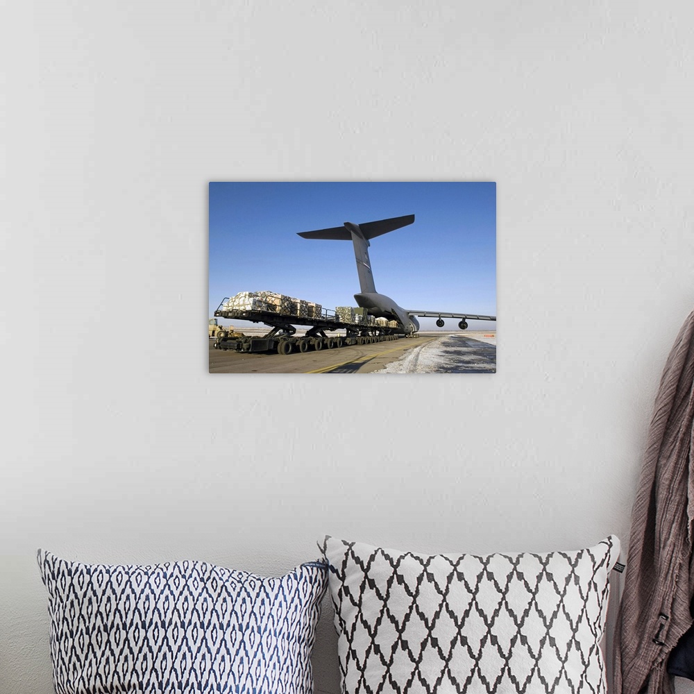 A bohemian room featuring Photograph of cargo being loaded into a plane.