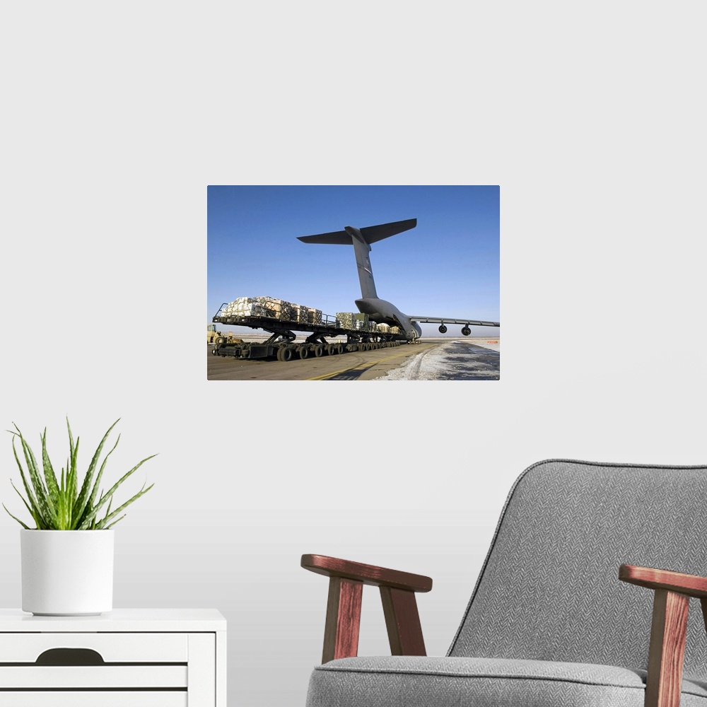 A modern room featuring Photograph of cargo being loaded into a plane.