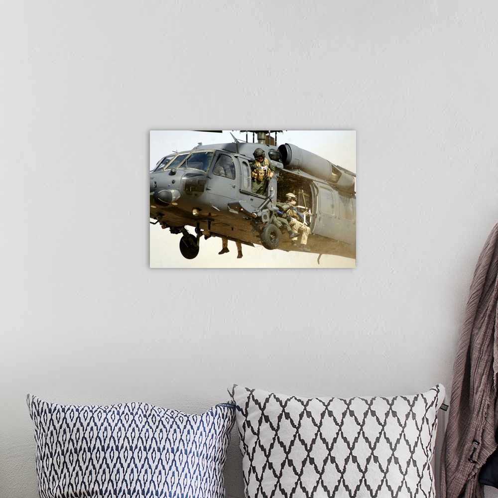 A bohemian room featuring Pararescuemen aboard a helicopter prepare for landing