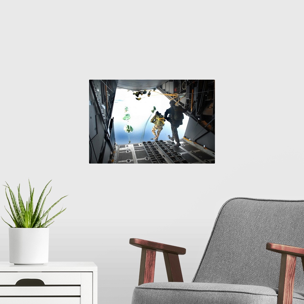 A modern room featuring Pararescuemen perform a static-line jump out of a C-130 Hercules.