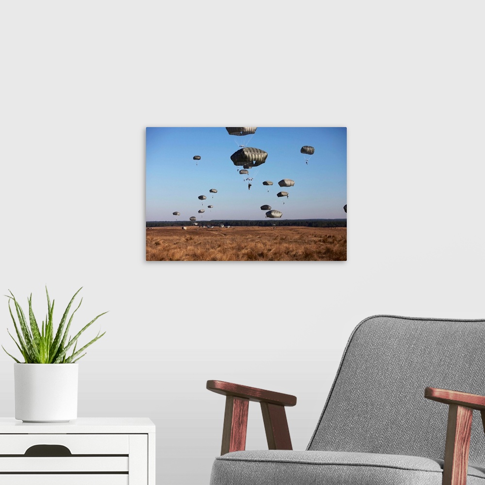 A modern room featuring Paratroopers fill the sky for Operation Toy Drop at Fort Bragg, North Carolina.